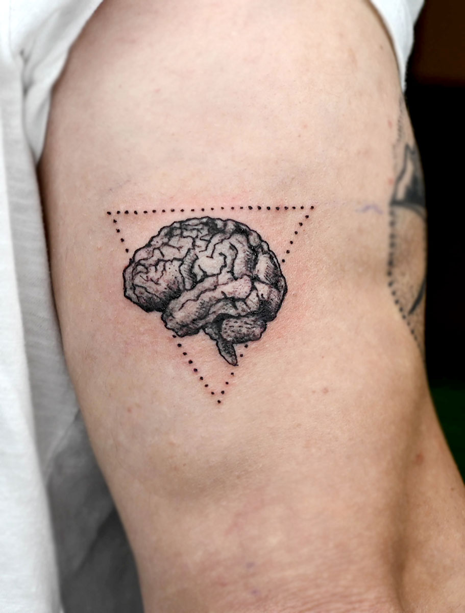 Heart vs. brain tattoo located on the inner forearm.
